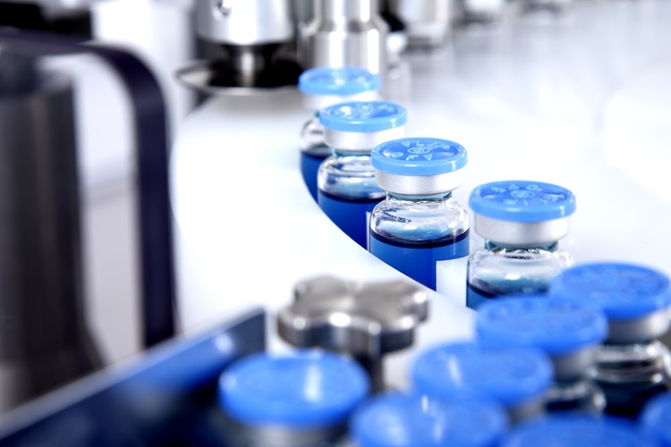 Yellow pills on a manufacturing rack
