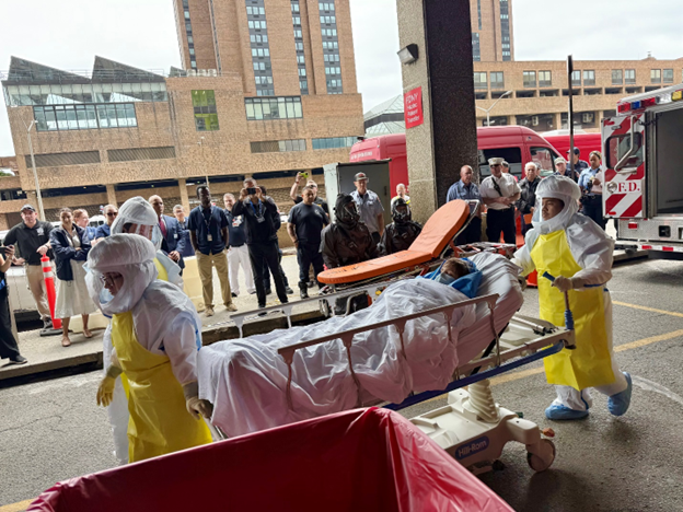 A mock pediatric patient is transferred by an EMS team