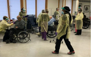 Photo of staff administering mAbs to elderly veterans