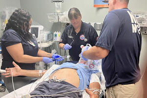 NDMS team treat an elderly patient in the ER